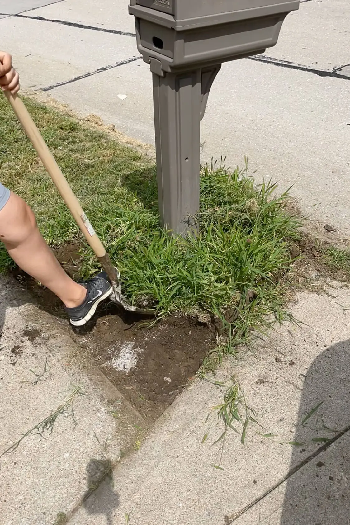 Removing weeds and brick edging around an old mailbox. 